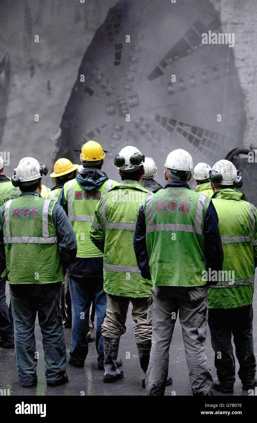 Construction workers watch as the Tunnel Boring Machine(TBM) breaks