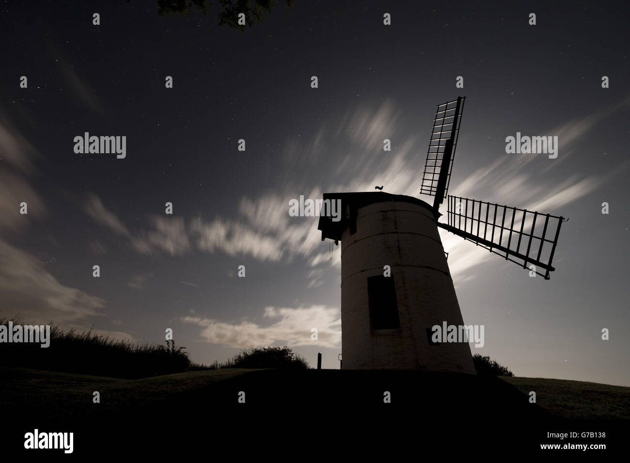 Clouds and an extremely bright moon make meteor spotting difficult during the perseids meteor shower near Ashton Windmill in Somerset. Stock Photo