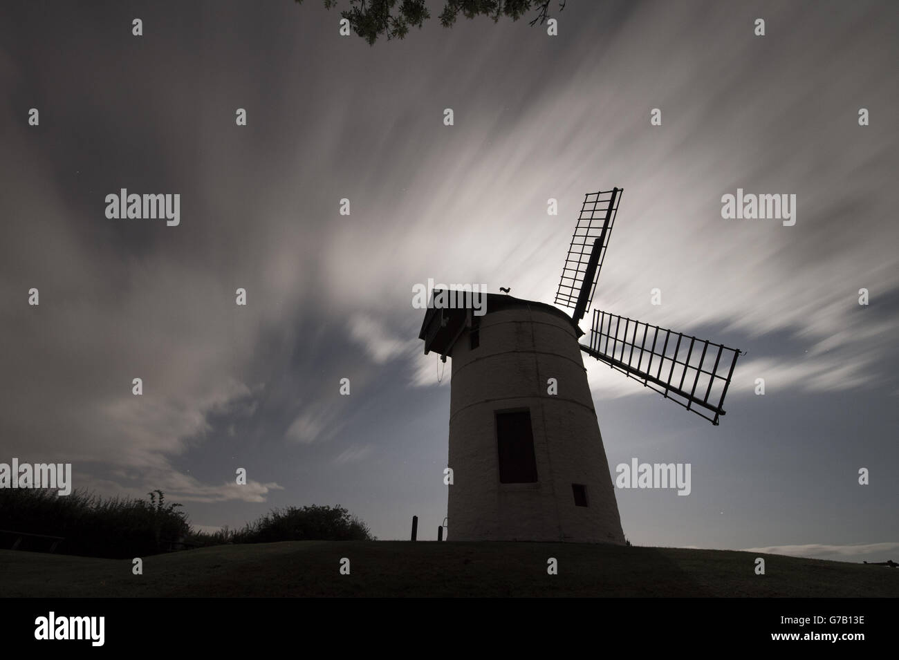 Clouds and an extremely bright moon make meteor spotting difficult during the perseids meteor shower near Ashton Windmill in Somerset. Stock Photo