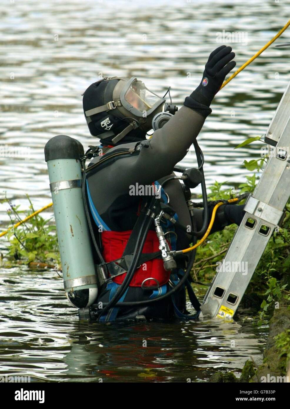A police diver searches clues in river walton on thames hires stock