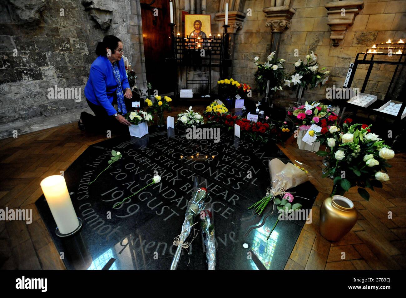 Margaret Lockwood Croft, who lost her 26 year-old son Shaun Lockwood Croft , in the Marchioness disaster on the River Thames, looks at flowers left on the memorial following a service at Southwark Cathedral, Southwark, south London, to mark the 25th anniversary of the sinking of the pleasure cruiser on the River Thames in London, which claimed 51 lives when the craft was hit by the Bowbelle Thames dredger. Stock Photo
