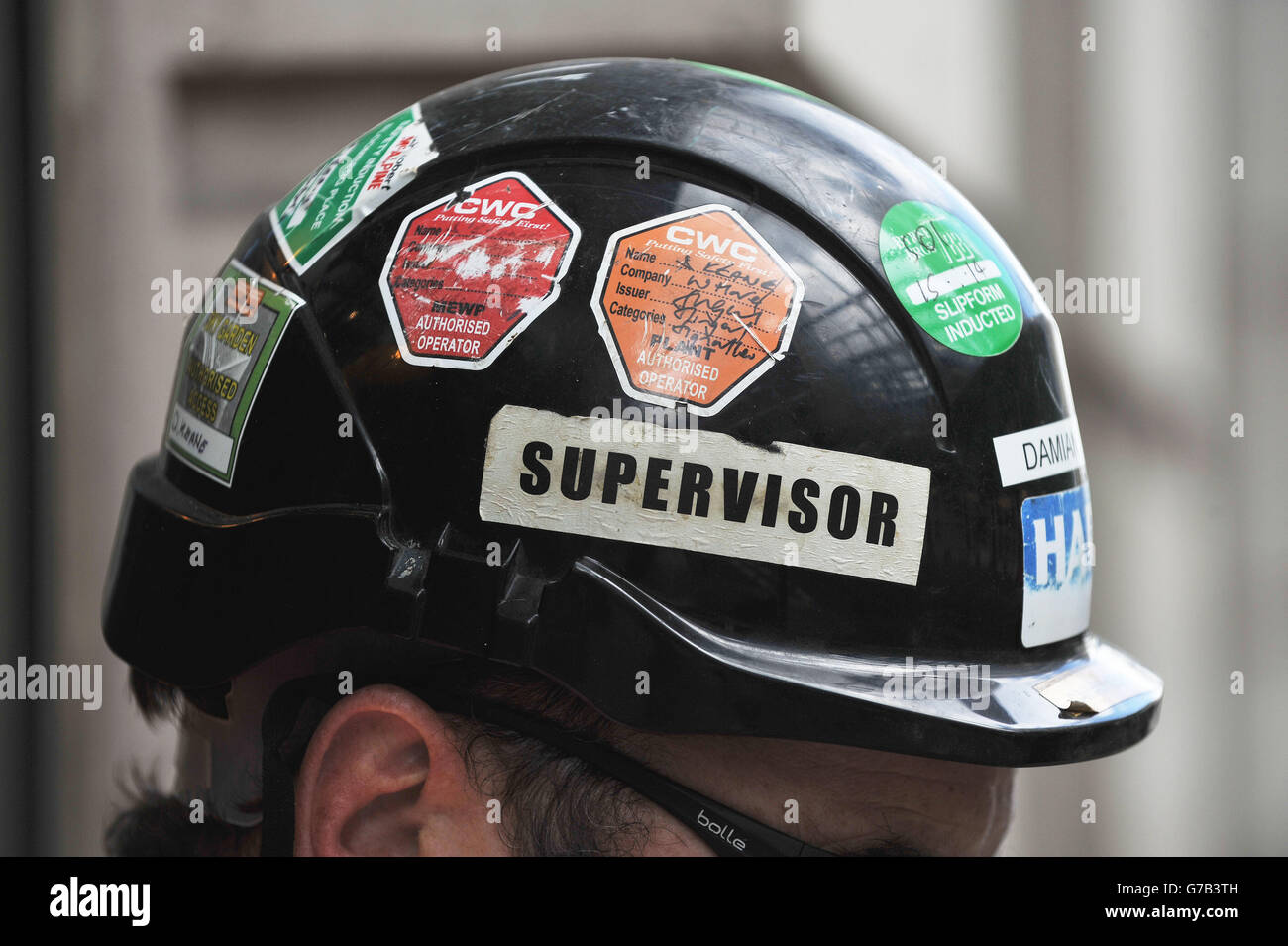 Stock photo of safety stickers on the hard hat of a construction worker at  the site of the new offices of Bloomberg situated between Mansion House and  Cannon Street stations in the