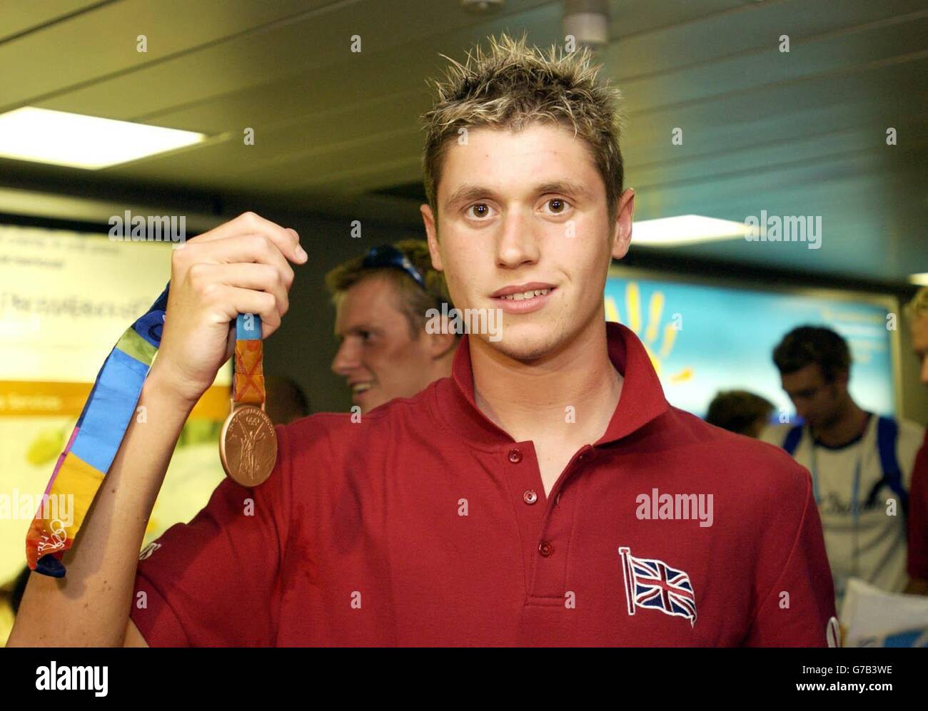 British Olympic swimmer David Davies shows off his bronze medal won in