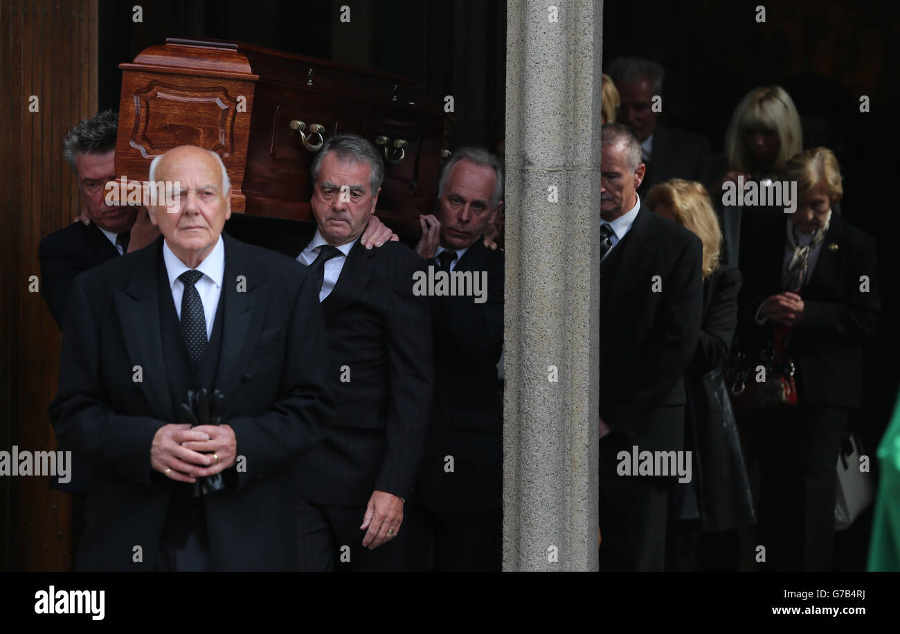 The coffin is carried by Undertones Bass Guitar player and Radio Ulster Producer Michael Bradley (left) and Co-Host Sean Coyle (right) during the funeral of BBC broadcaster Gerry Anderson at St Eugene's Cathedral in Londonderry. Stock Photo