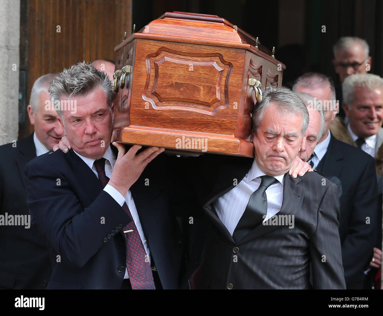 The coffin is carried by Undertones Bass Guitar player and Radio Ulster  Producer Michael Bradley (left) and Co-Host Sean Coyle (right) during the  funeral of BBC broadcaster Gerry Anderson at St Eugene's
