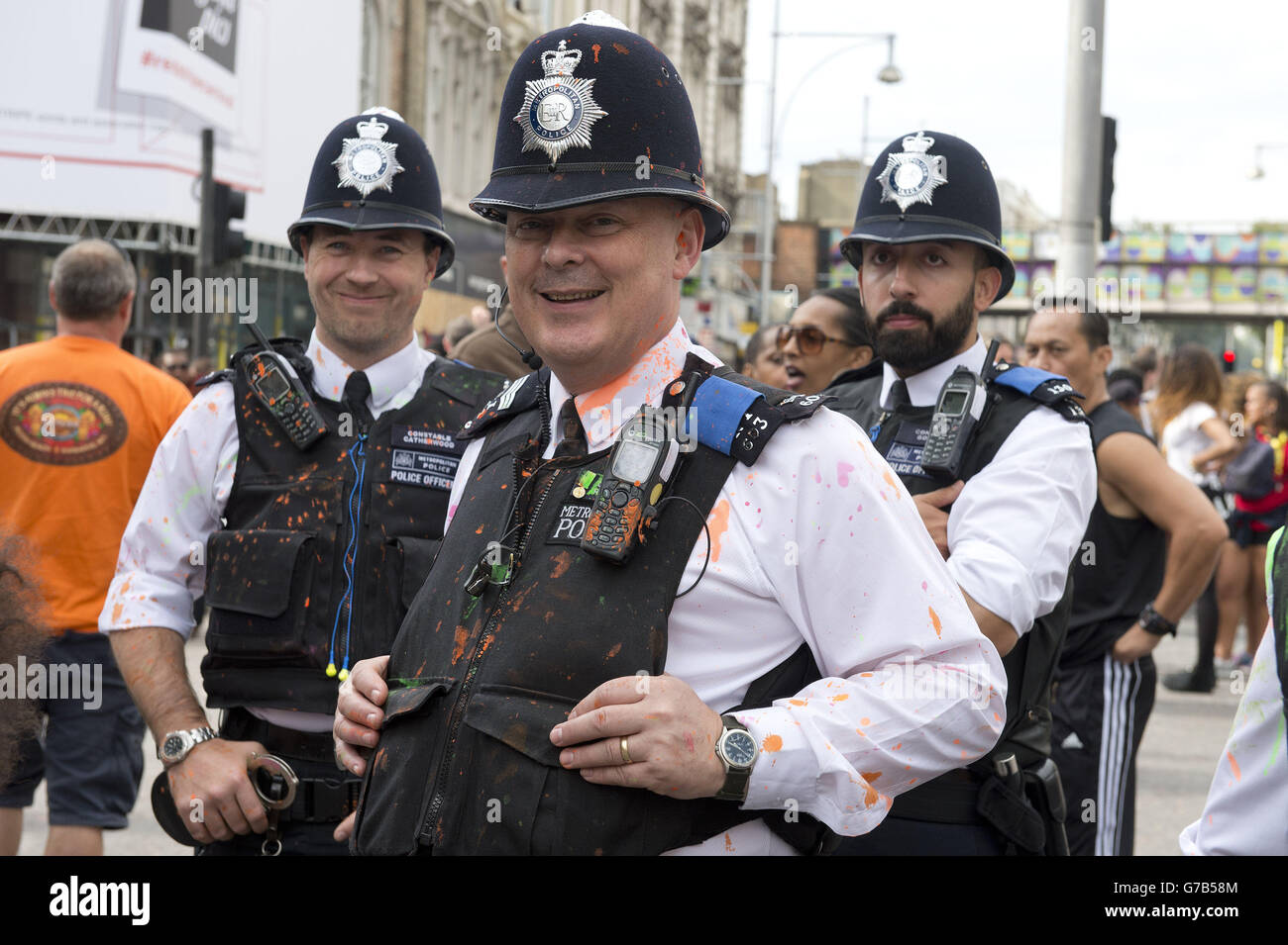 Policemen splattered with paint at the Notting Hill Carnival family day, west London. Stock Photo