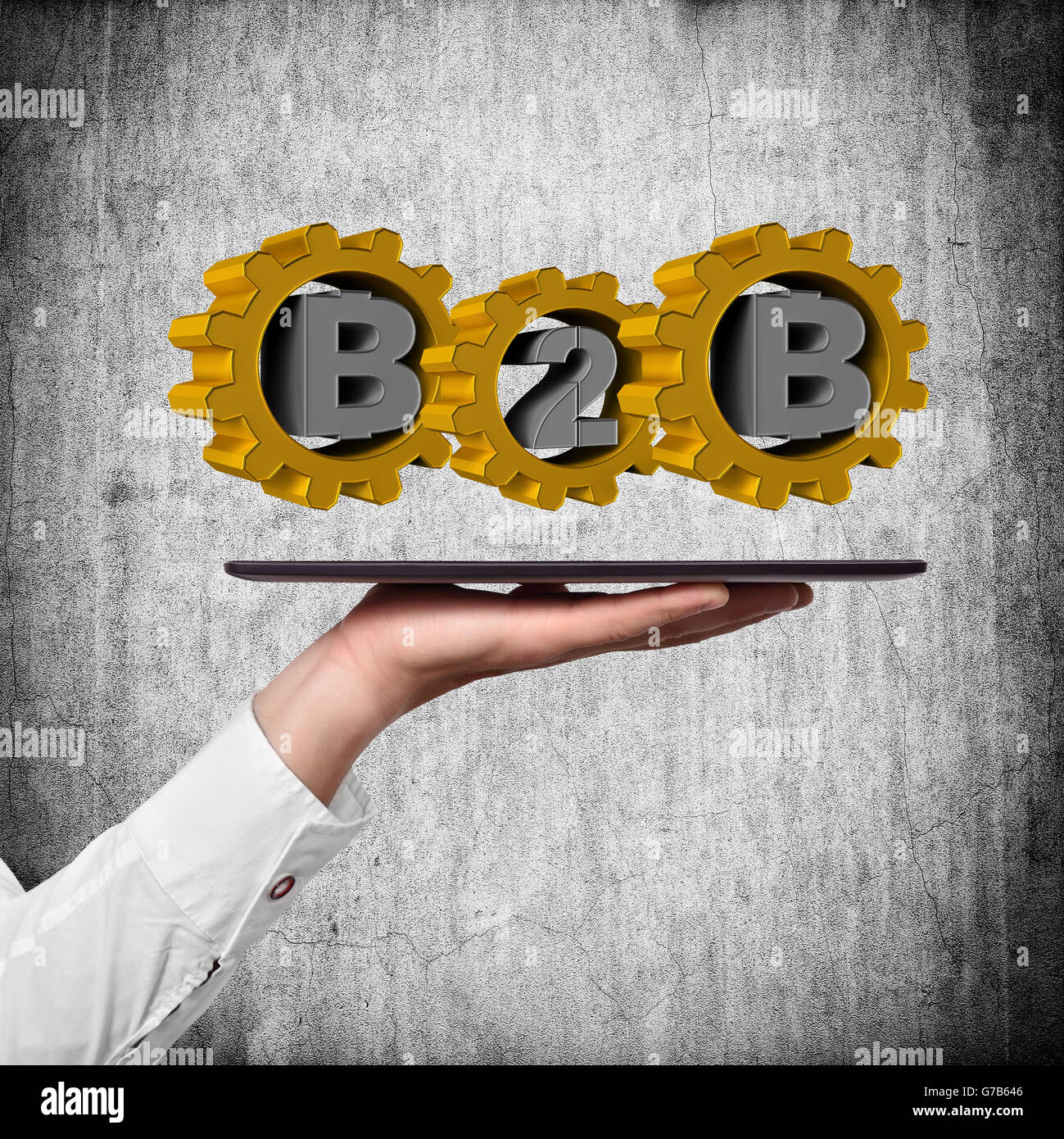 hand holding tablet with b2b symbol on a wall background Stock Photo