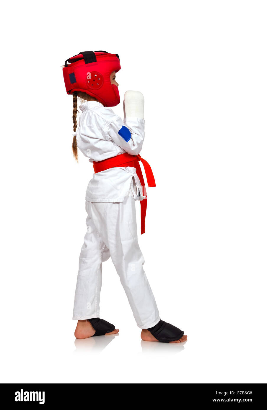 little karate girl in a helmet in training Stock Photo