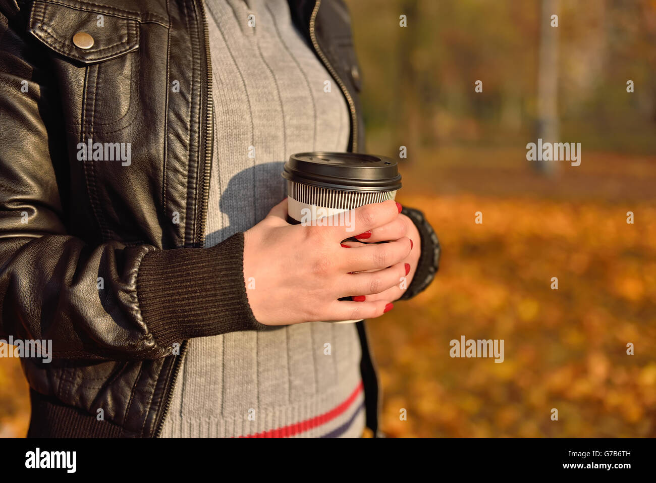 girl holding coffee cup in hand. Vintage photo Stock Photo