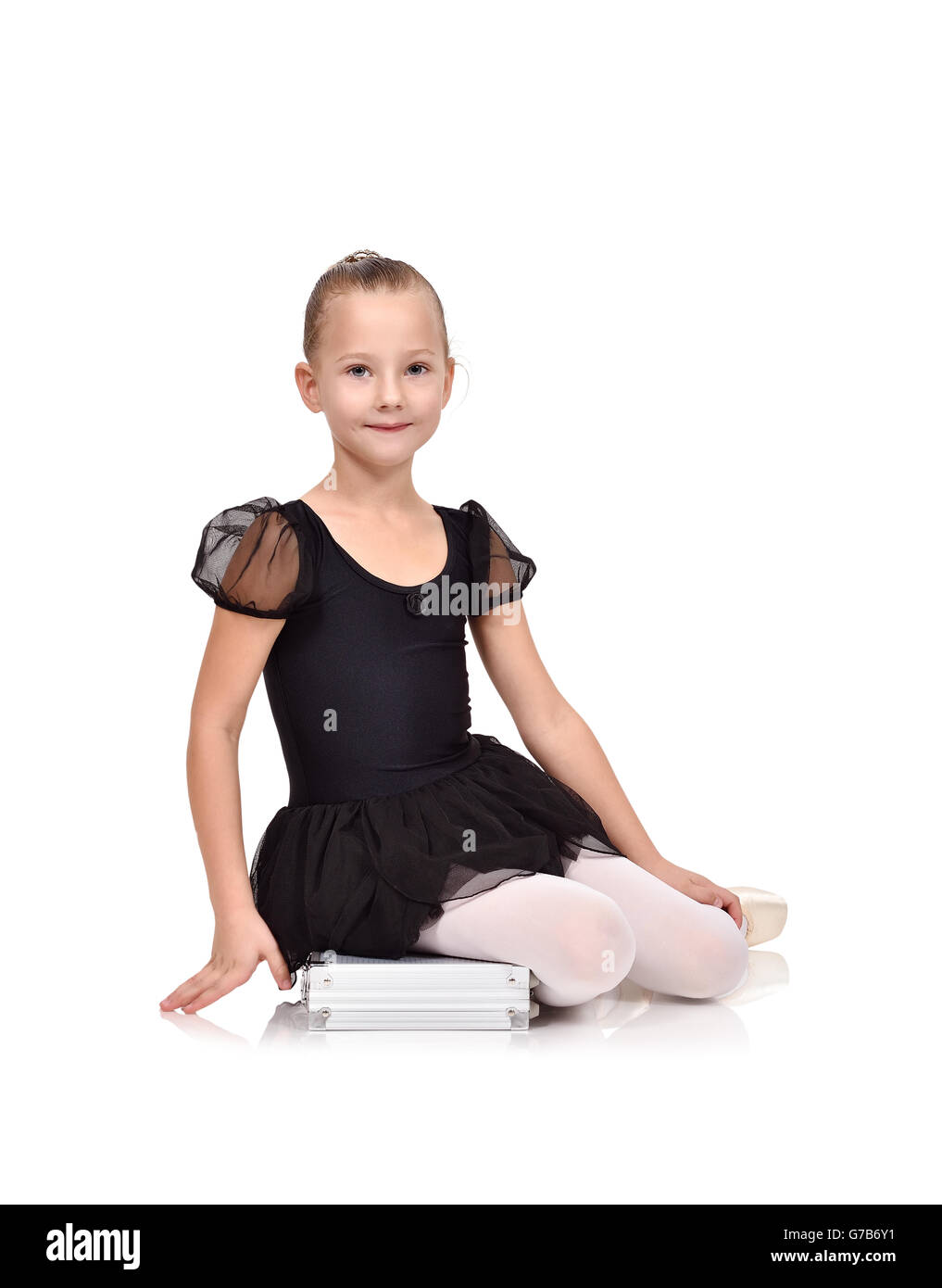 ballerina in black tutu sitting on case on white background Stock Photo ...