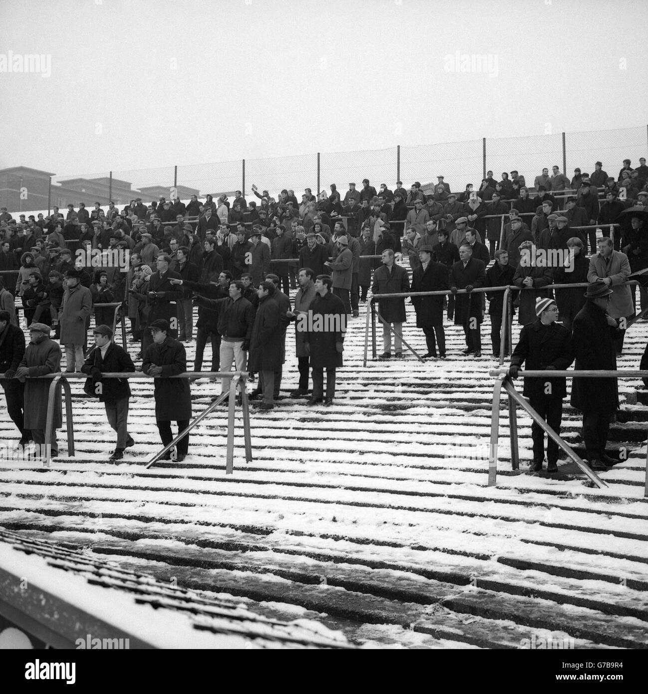 Soccer - English Division One - Arsenal v Sheffield Wednesday - Highbury. A section of the terrace showing a few ardent supporters amongst the snow. Stock Photo