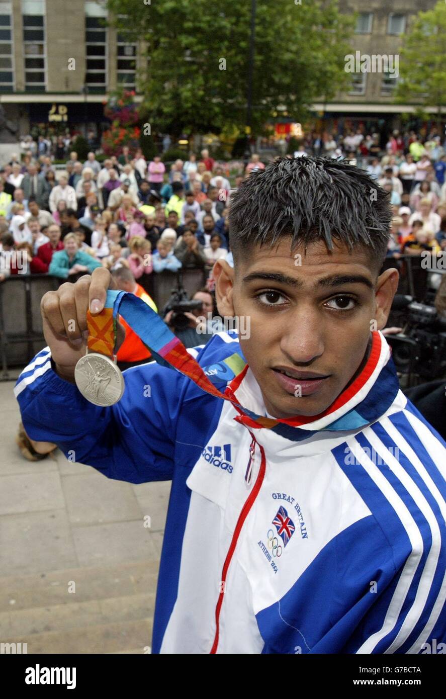 British Olympic silver medal winning boxer Amir Khan, shows his medal, on an open-top bus tour of his home town of Bolton. Stock Photo