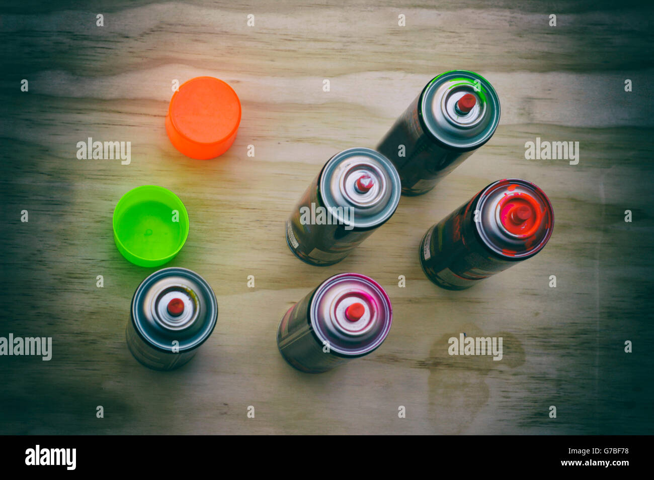 Photograph of some spray paint cans on a wood table Stock Photo Alamy