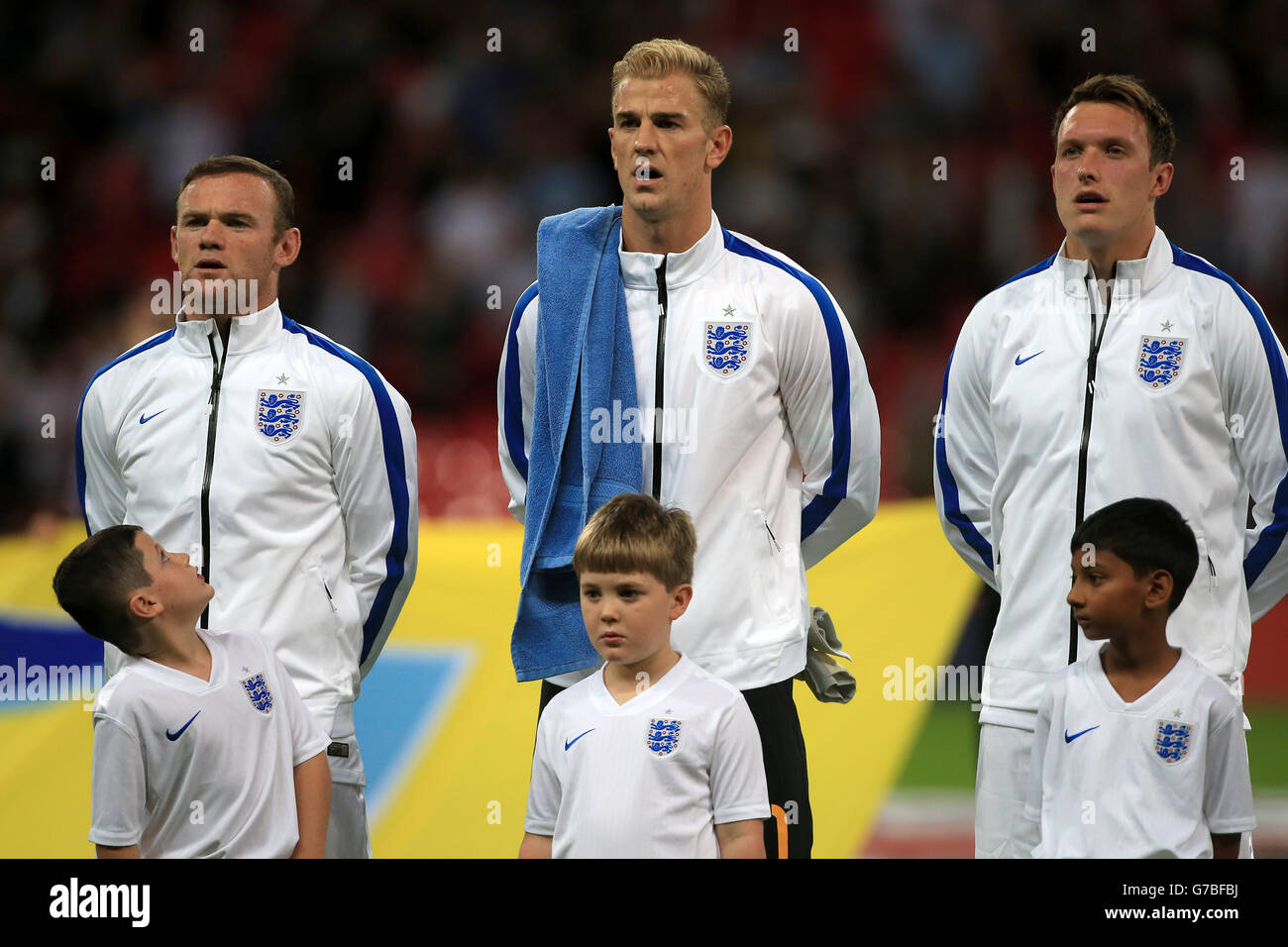 (left to right) England's Wayne Rooney, Joe Hart and Phil Jones sing the national anthem before the International Friendly at Wembley Stadium, London. PRESS ASSOCIATION Photo. Picture date: Wednesday September 3, 2014. See PA story SOCCER England. Photo credit should read: Nick Potts/PA Wire. RESTRICTIONS: Use subject to FA restrictions. Editorial use only. Commercial use only with prior written consent of the FA. No editing except cropping. Call +44 (0)1158 447447 or see www.paphotos.com/info/ for full restrictions and further information. Stock Photo
