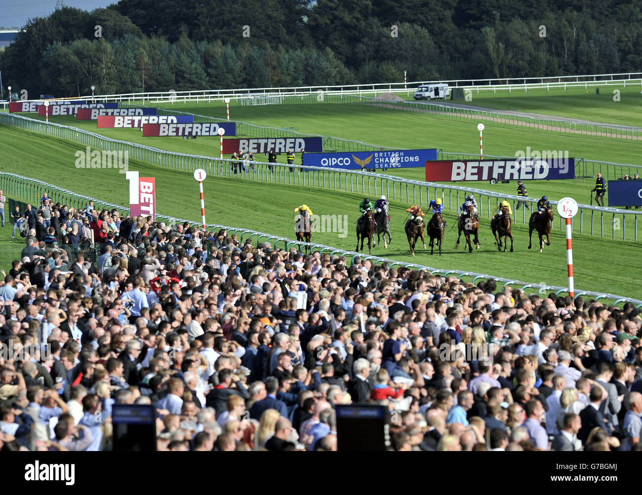 Packed grandstands watch the runners in the Betfred Goals Galore Nursery Handicap during the