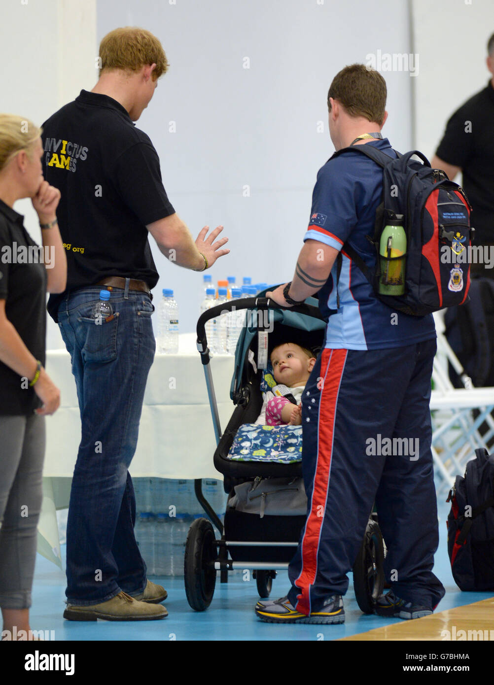 Prince Harry meets a competitors baby as he watches the USA wheelchair