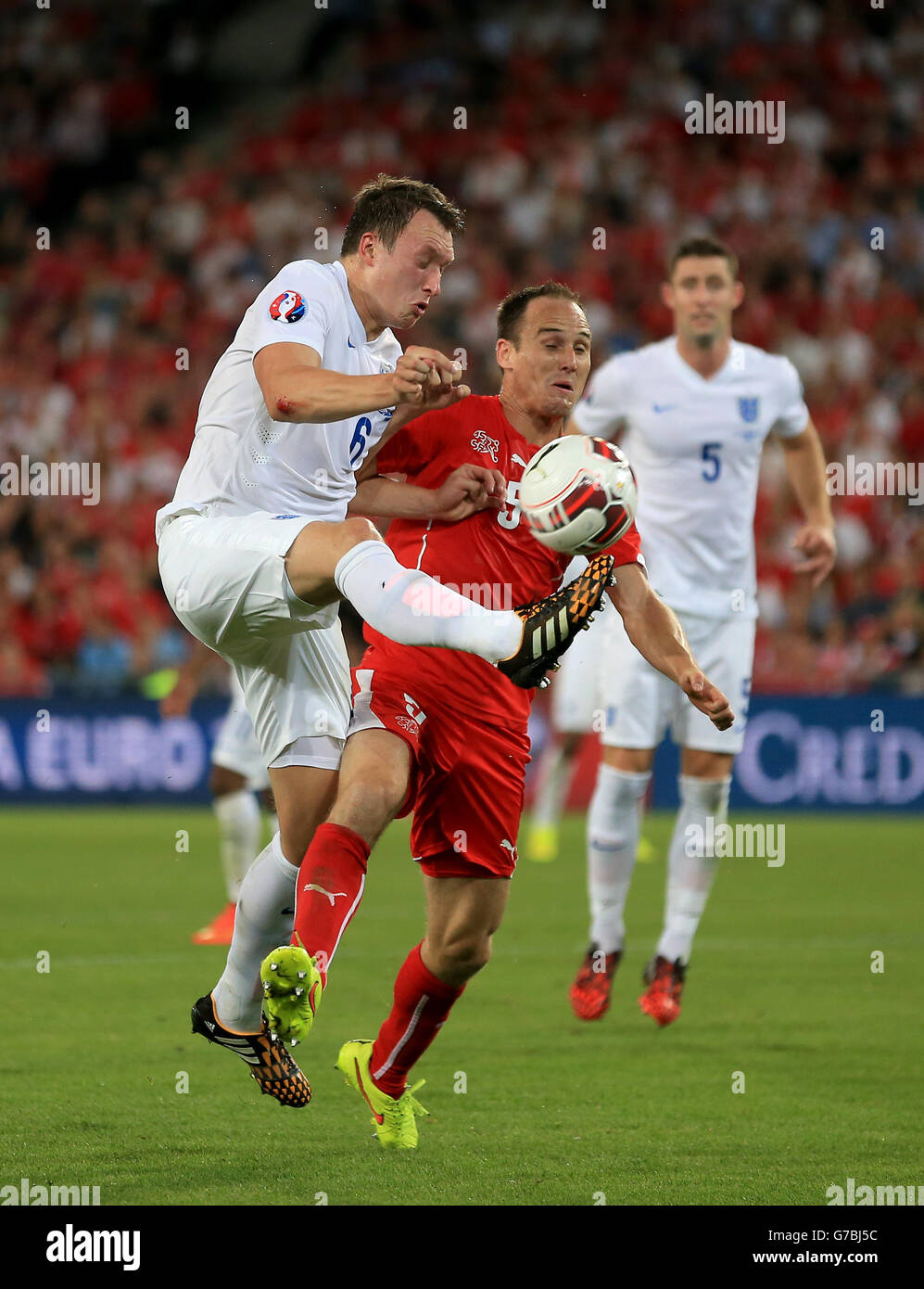 England's Phil Jones and Switzerland's Steve Von Bergen battle for the ball during a UEFA Euro 2016 qualifying, Group E match at the St Jakob-Park Stadium, Basel. Stock Photo