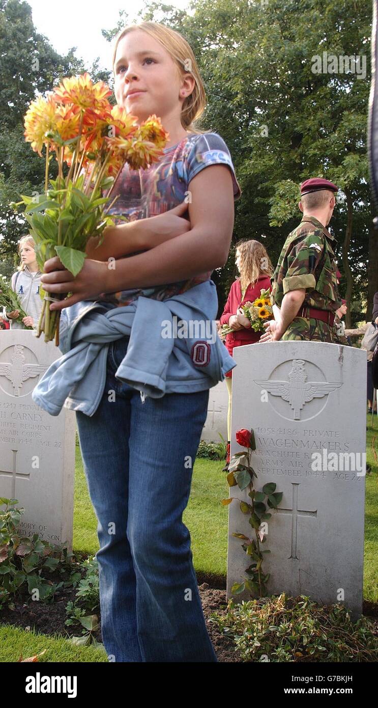 A young Dutch Schoolgirl prepares to lay a bunch of flowers on the grave of a British Paratrooper, at the British Airborne Cemetery, near Arnhem, Holland. The Prince of Wales and Queen Beatrix of the Netherlands joined more than 5,000 veterans and their families to remember those killed in the epic Battle of Arnhem exactly 60 years ago. Stock Photo
