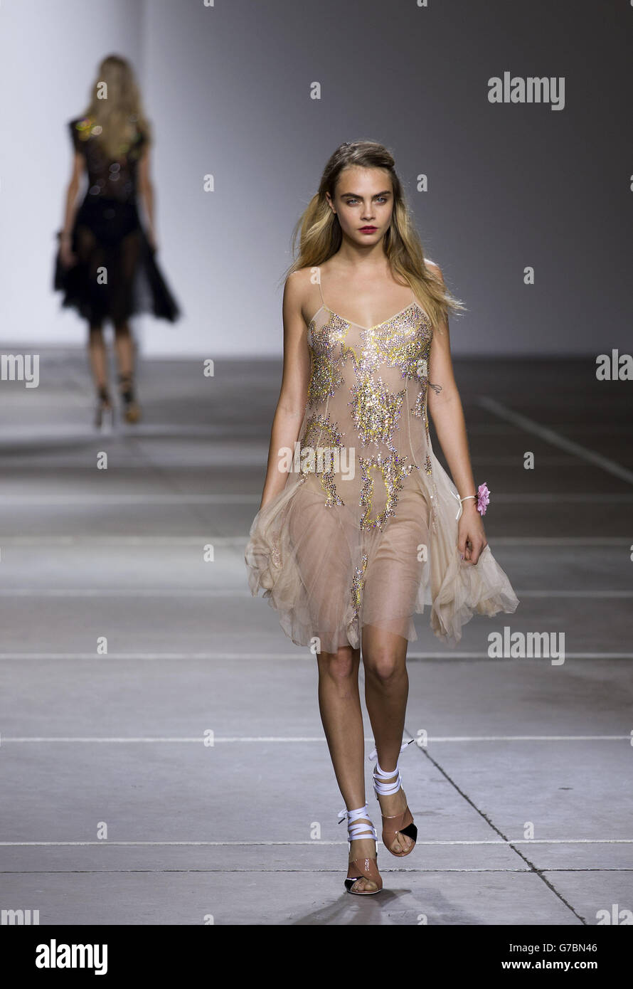 Cara Delevingne in the Topshop catwalk show at the Topshop Show Space in London during London Fashion Week. Stock Photo