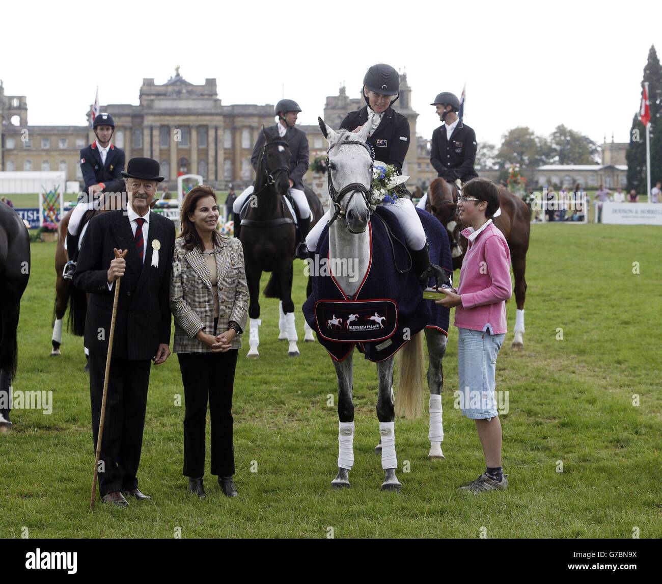 New Zealand's Jonelle Price riding Faerie Dianimo is presented with the trophy from the Duke and Duchess of Marlborough (left) after winning the CIC *** 8/9 year-olds competition on day four of the Blenheim Palace International Horse Trials in Oxfordshire. Stock Photo