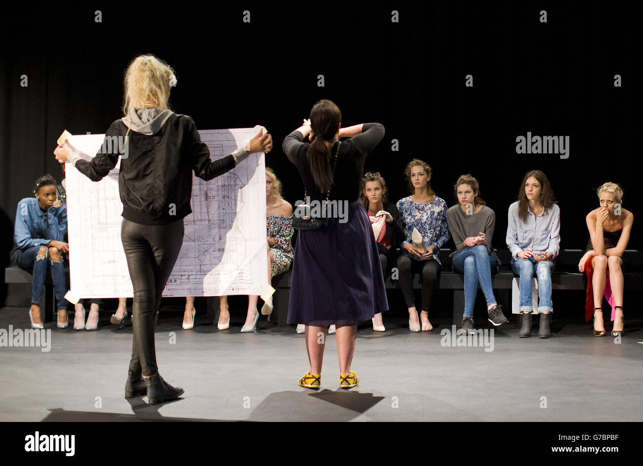 Models are instructed how to walk along the catwalk before the Emilio de la Morena catwalk show on 16 September 2014, during London Fashion Week. Stock Photo