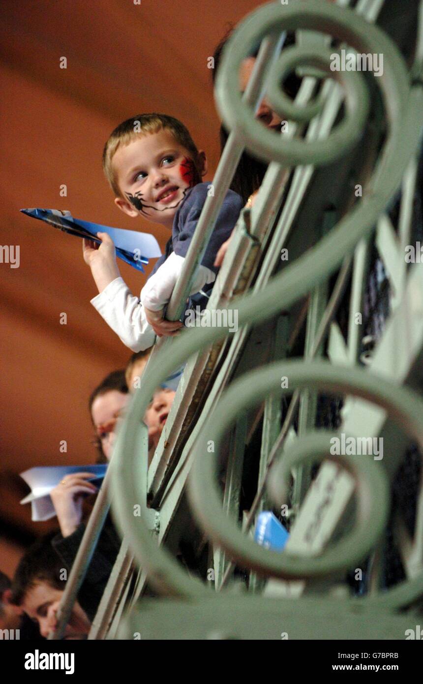 Ryan Winston, four and a half from Lucan Co Dublin, attempts to throw a paper dart from a balcony on to a target on a forty foot wide map of the world, thirty feet below him, to win 2 round the world tickets, at the Big Trip Holiday Show, at the Royal Dublin Society exhibition halls, Ballsbridge, Dublin, Ireland. Stock Photo
