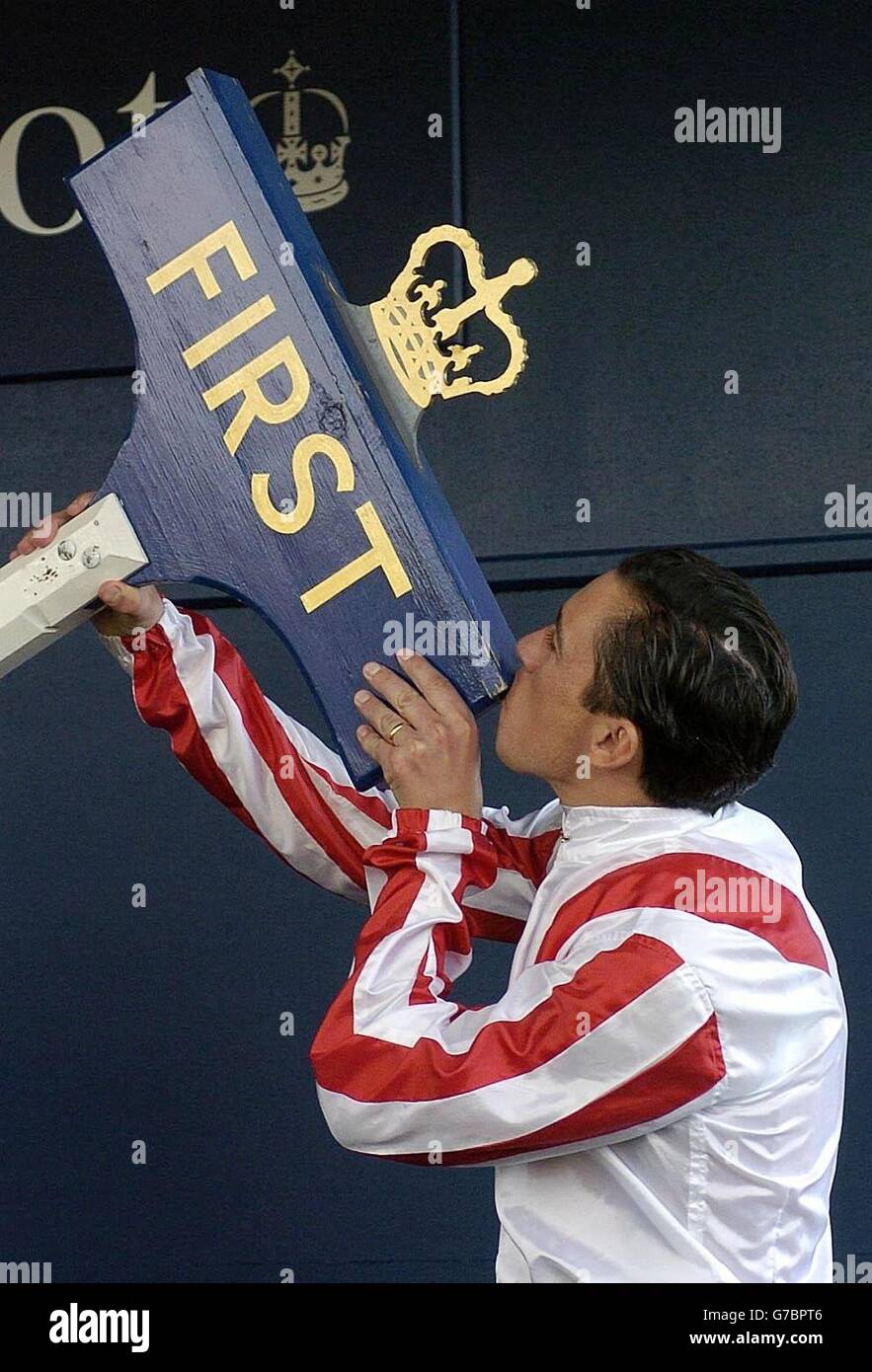 Jockey Frankie Dettori. Jockey Frankie Dettori kisses the winning post after being presented with it as a keepsake at Ascot Races. Stock Photo