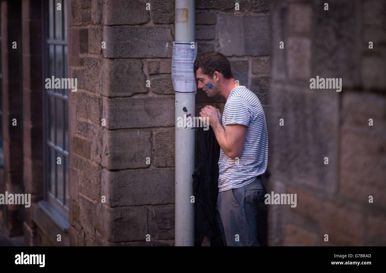 A dejected 'Yes' supporter in Edinburgh makes his way home in the early hours after Scotland voted decisively to reject independence and remain part of the Union. Stock Photo
