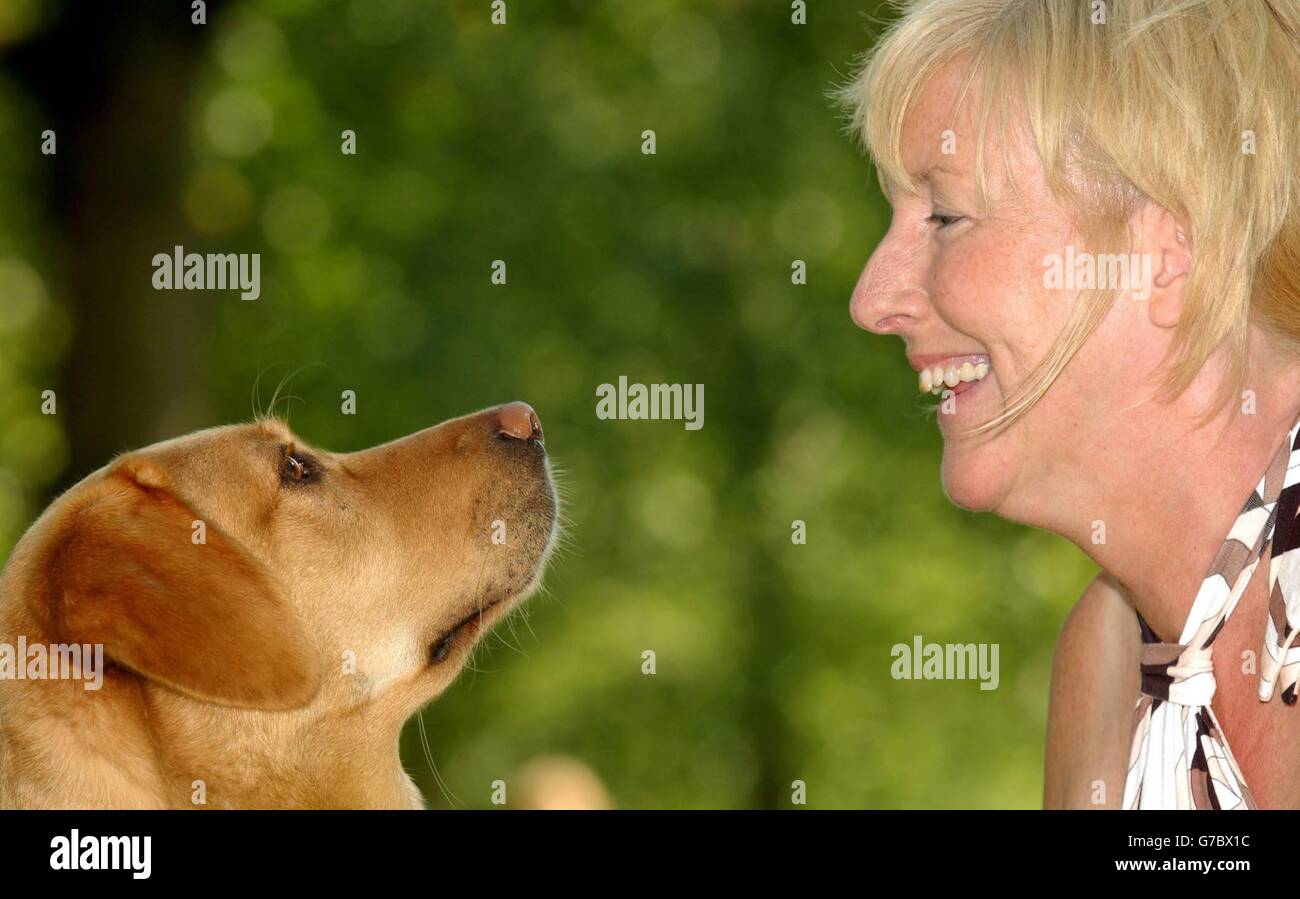 Owner Mhairi Thurston posing with Wanda, a two-year, 10 month old labrador-retriever cross who won the Guide Dog of Year competition - awarded by The Guide Dogs for the Blind Association - in Green Park, central London. Stock Photo