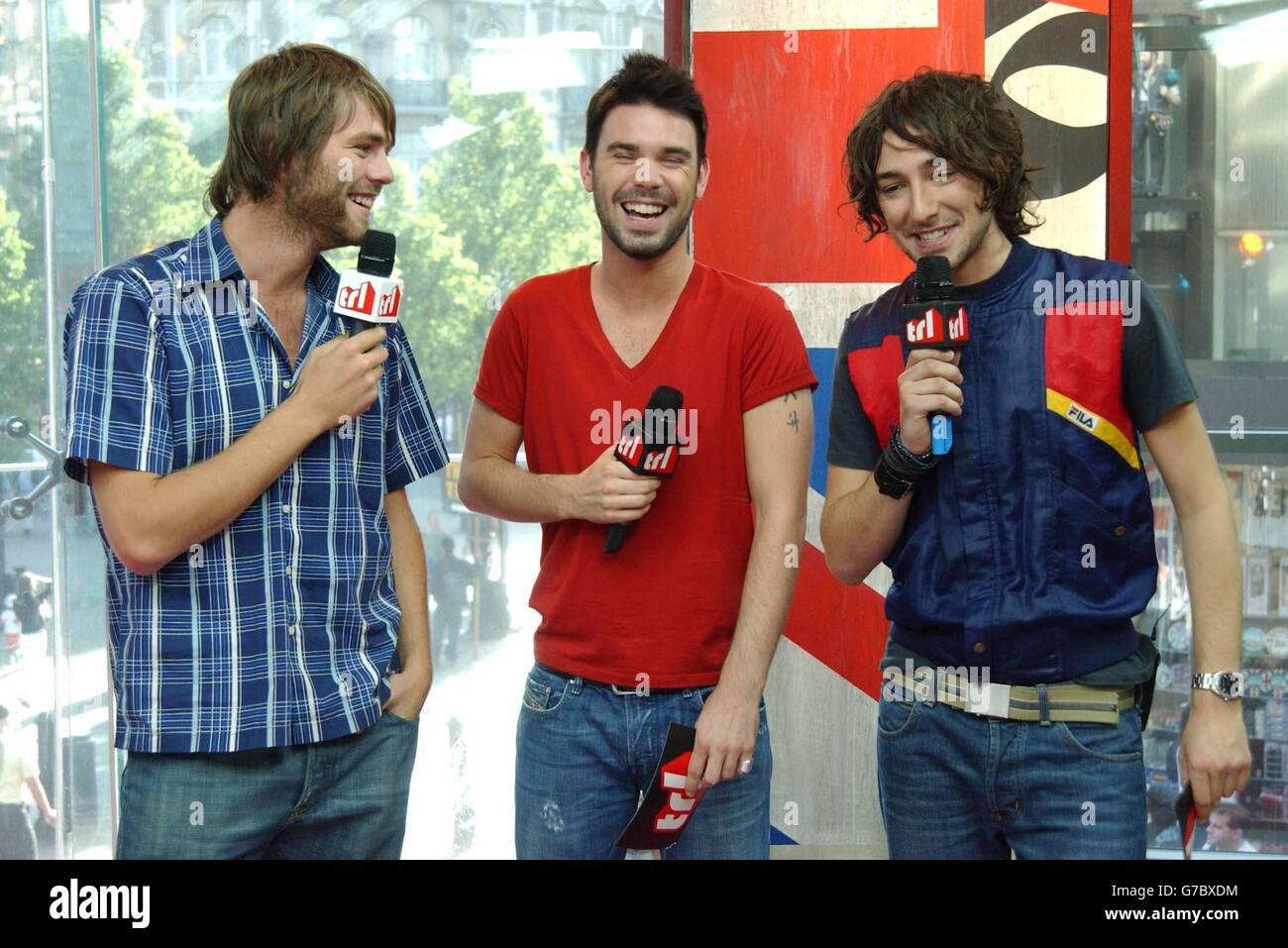 (From left to right) singer Brian McFadden with MTV presenters Dave Berry and Alex Zane during his guest appearance on MTV's TRL - Total Request Live - show, at the new studios in Leicester Square, central London. Stock Photo