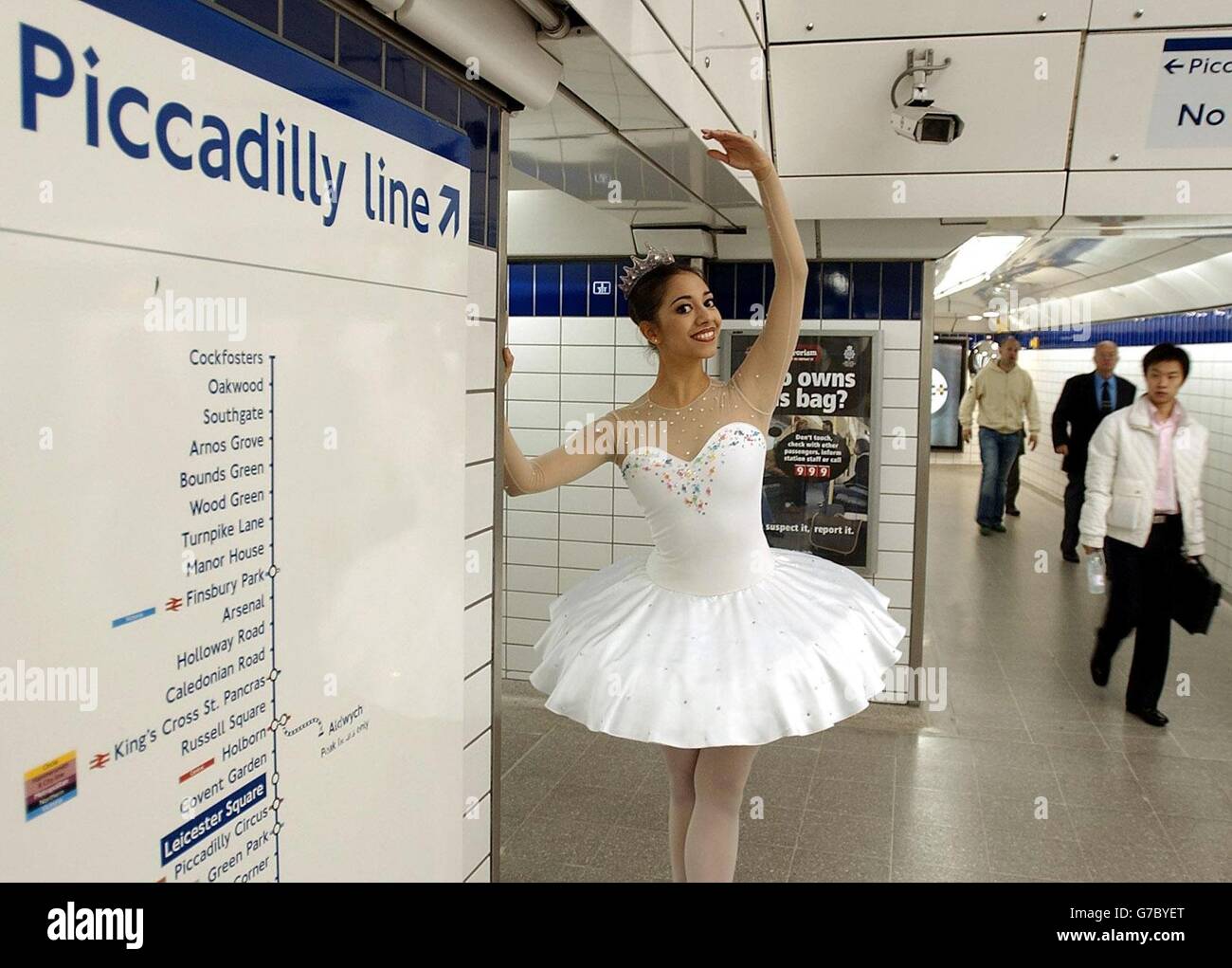 English National Ballet (ENB) ballerina Begona Cao stands by a sign after  dancing on a busking spot at Leicester Square tube station in central  London. The ENB launched a poster campaign designed