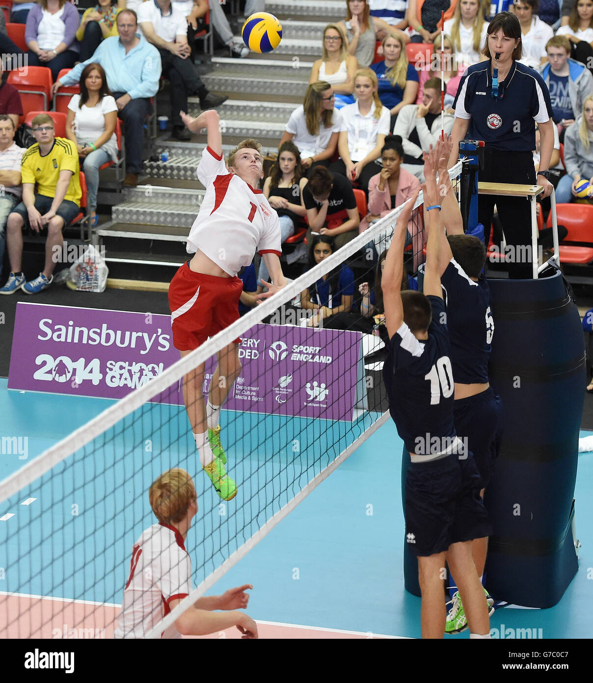 England Junoir Men's William Van Wingerden smashes the ball during the game with Scotland West Boys, in the final of the Volleyball, during the Sainsbury's 2014 School Games at The Sugden Centre, Manchester. Stock Photo