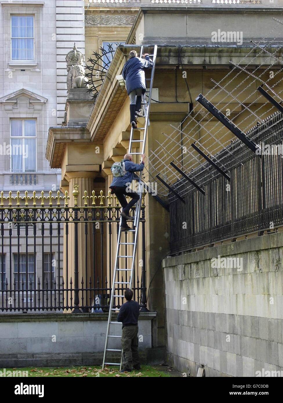 The Fathers 4 Justice demonstrator Jason Hatch (top), 33, from Gloucester, who later dressed as Batman scales the outer fence into the grounds of Buckingham Palace to stage his protest on the ledge of the palace with Dave Pyke who was later wearing a Robin costume (below). Stock Photo