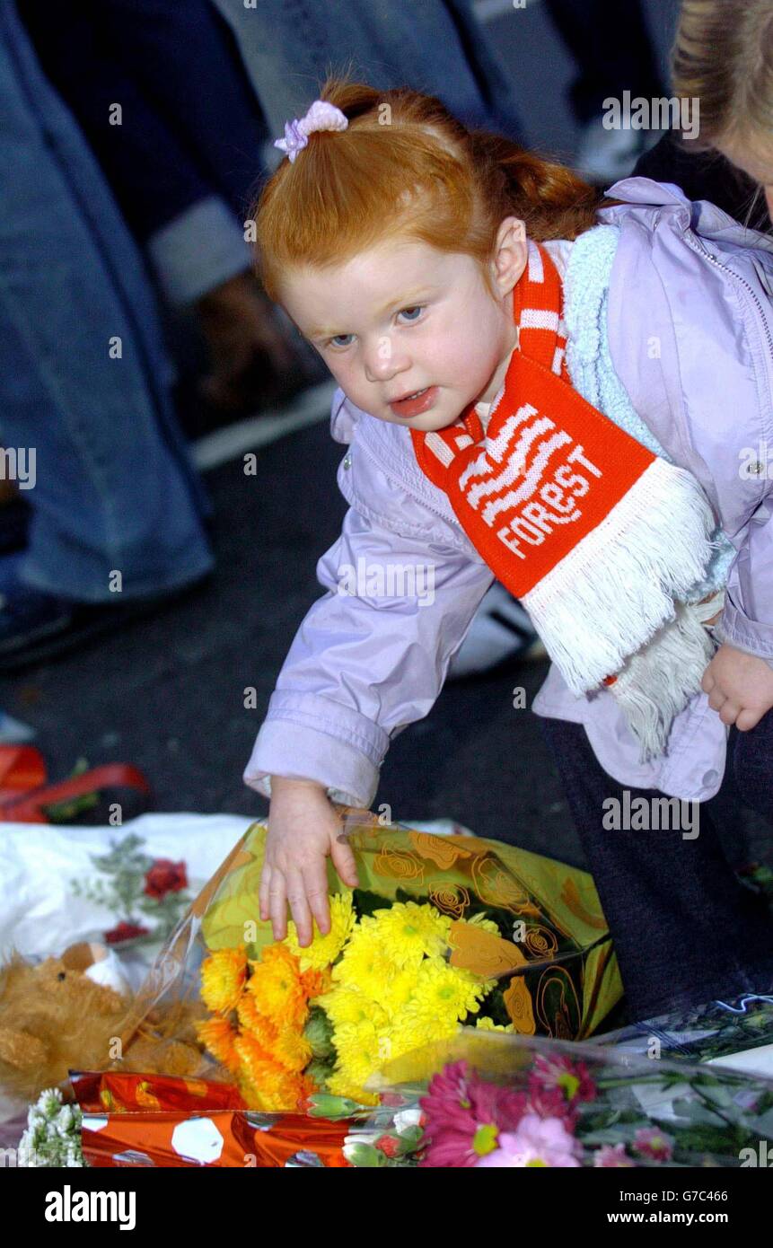 Emily Lyndsay (age 2) from Nottingham with floral tributes to Brian Clough prior to Nottingham Forrest's Carling Cup second round match against Rotherham at the City Ground, Nottingham. Stock Photo