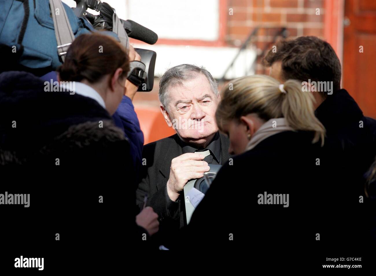 Father John Thompson speaks to reporters outside the home of Elizabeth Bigley, mother of Ken Bigley who is being held hostage in Iraq. Stock Photo