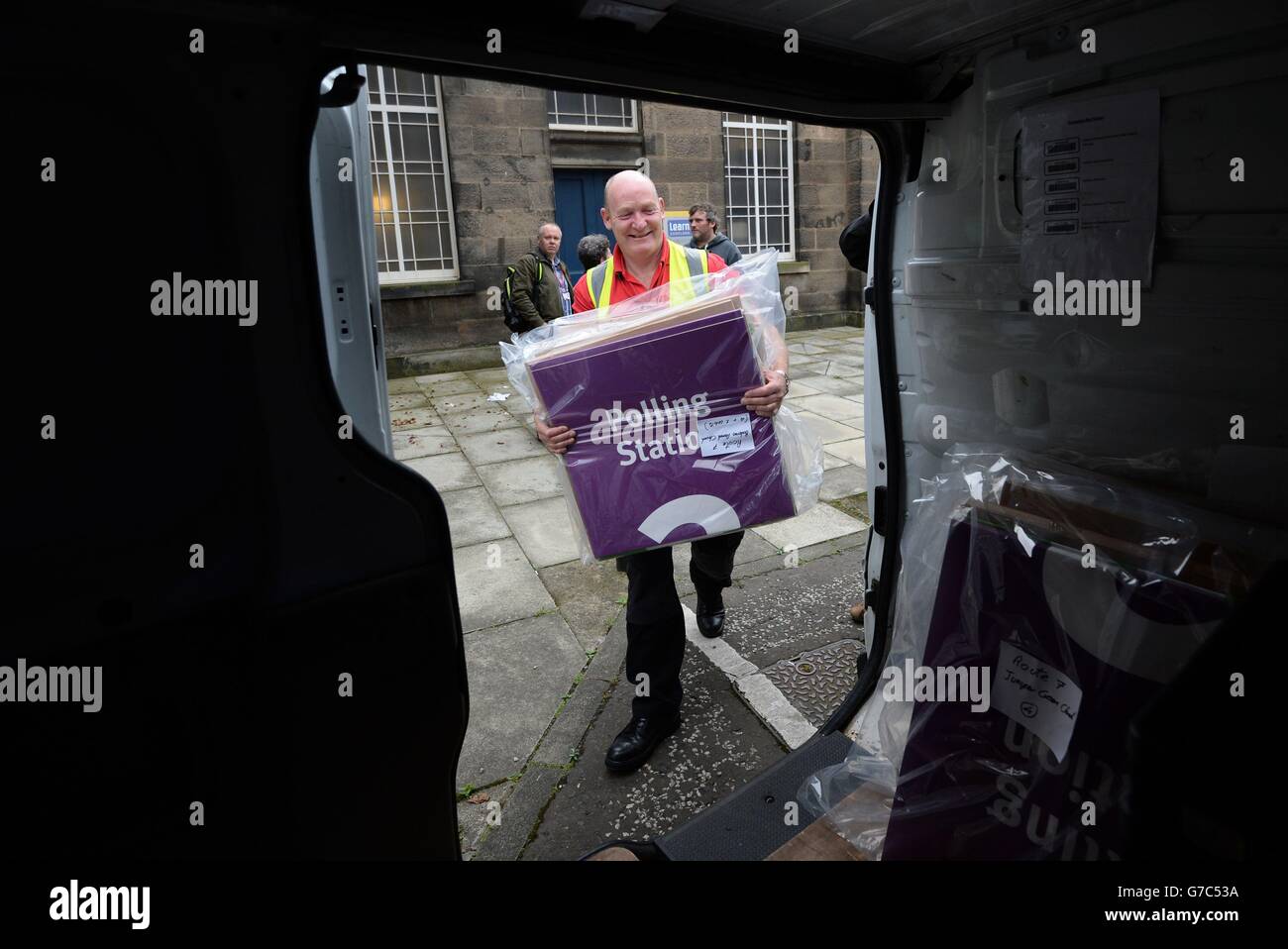 Ballot boxes and polling station signs are loaded into vans in Edinburgh to be taken to polling stations across Scotland ahead of the independence referendum. Stock Photo