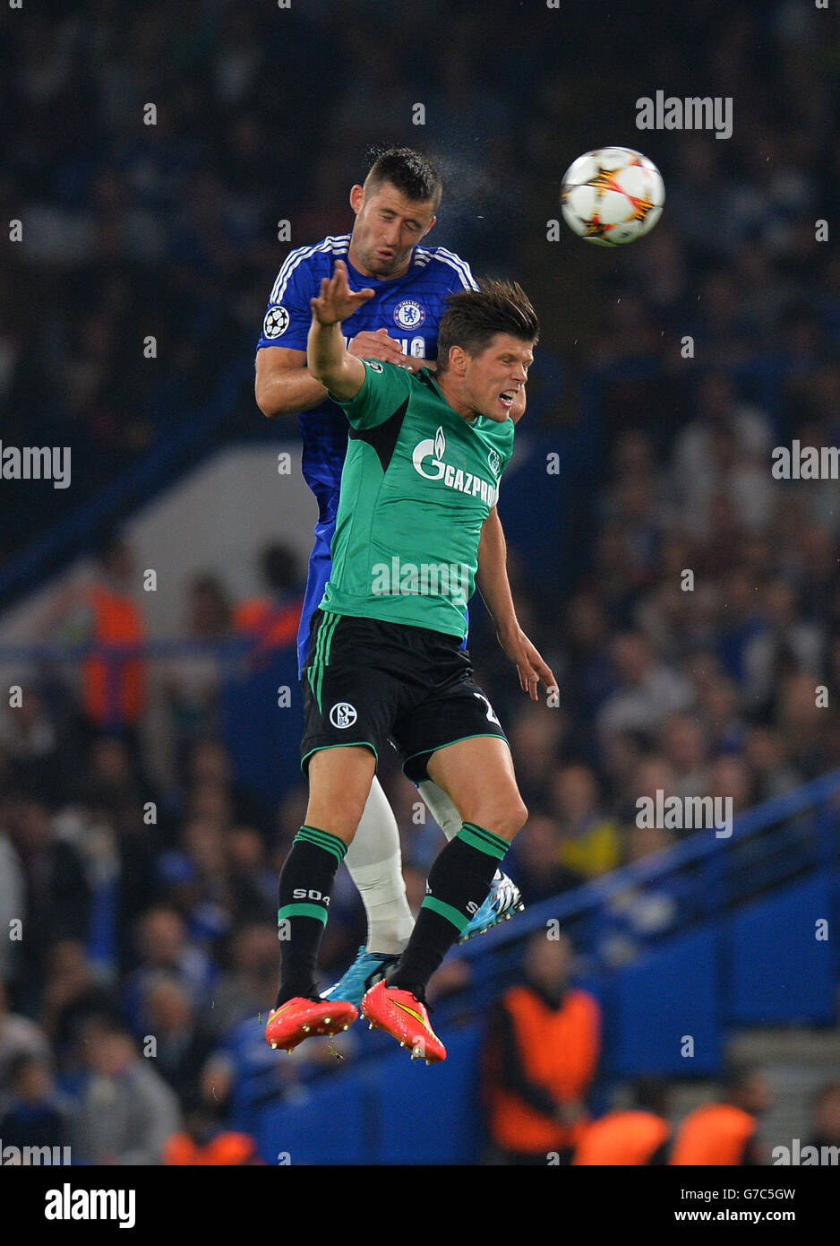 Chelsea's Gary Cahill (top) wins the ball in the air from FC Schalke's Klaas-Jan Huntelaar during the UEFA Champions League, Group G match at Stamford Bridge, Liverpool. Stock Photo