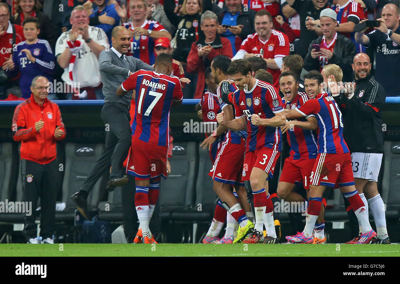 Bayern Munich's Jerome Boateng (17) celebrates with manager Pep Guardiola scoring his side's first goal Stock Photo