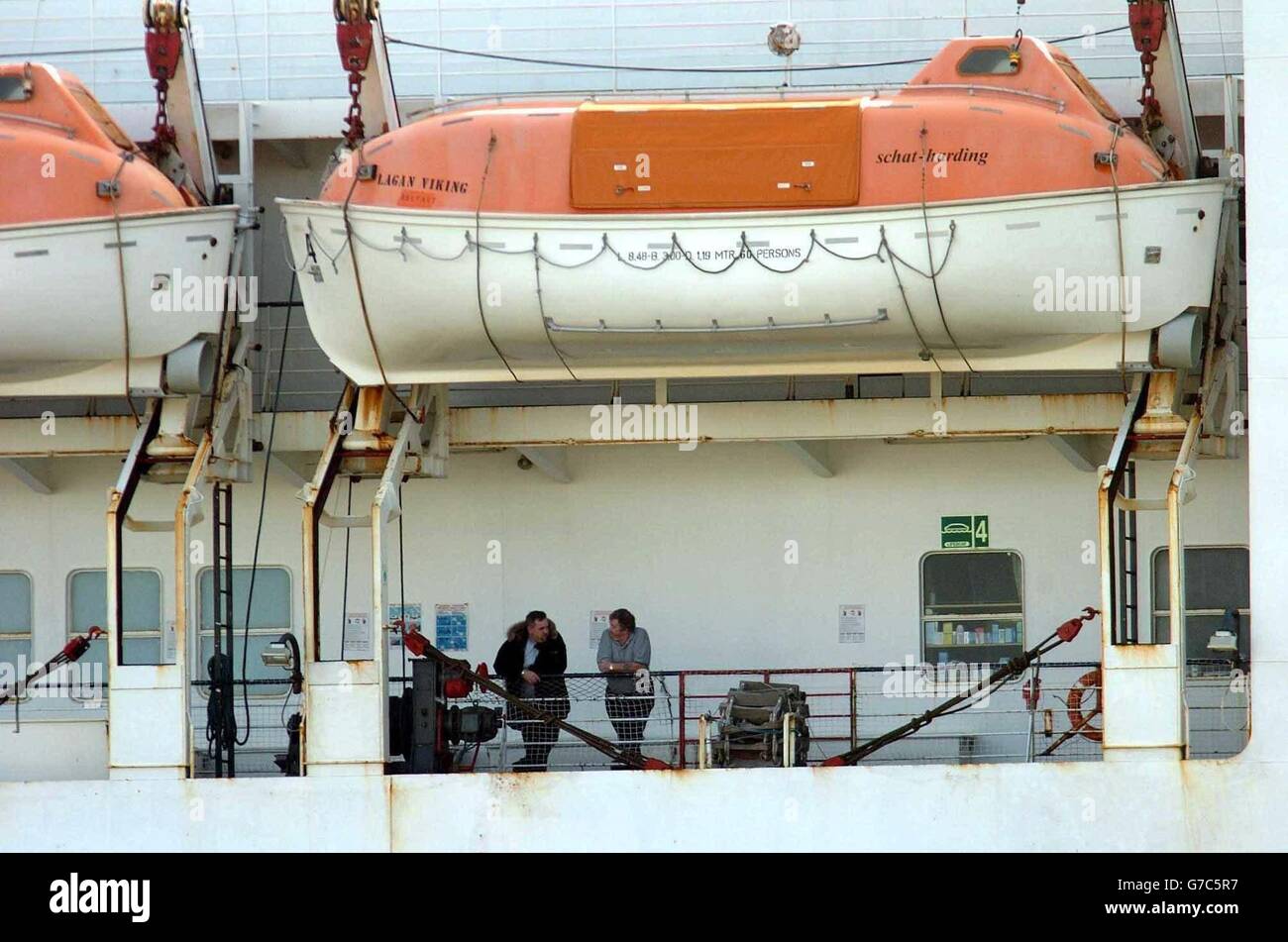 Two passengers on the Lagan Viking ferry outside Belfast. Around 70 people have been stuck on a passenger ferry bound for Belfast for 24 hours because it is unable to dock in the city. The boat left Liverpool 24 hours ago but was unable to reach its destination because the crew haven't been able to open the doors. Stock Photo