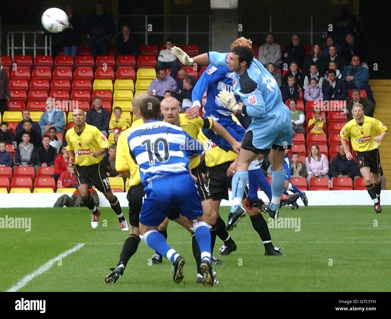 Watford's goalie Richard Lee, right, punches the ball away to foil a Reading attack during the Coca-Cola Championship match at Vicarage Road, Watford, Saturday September 25, 2004. . Stock Photo
