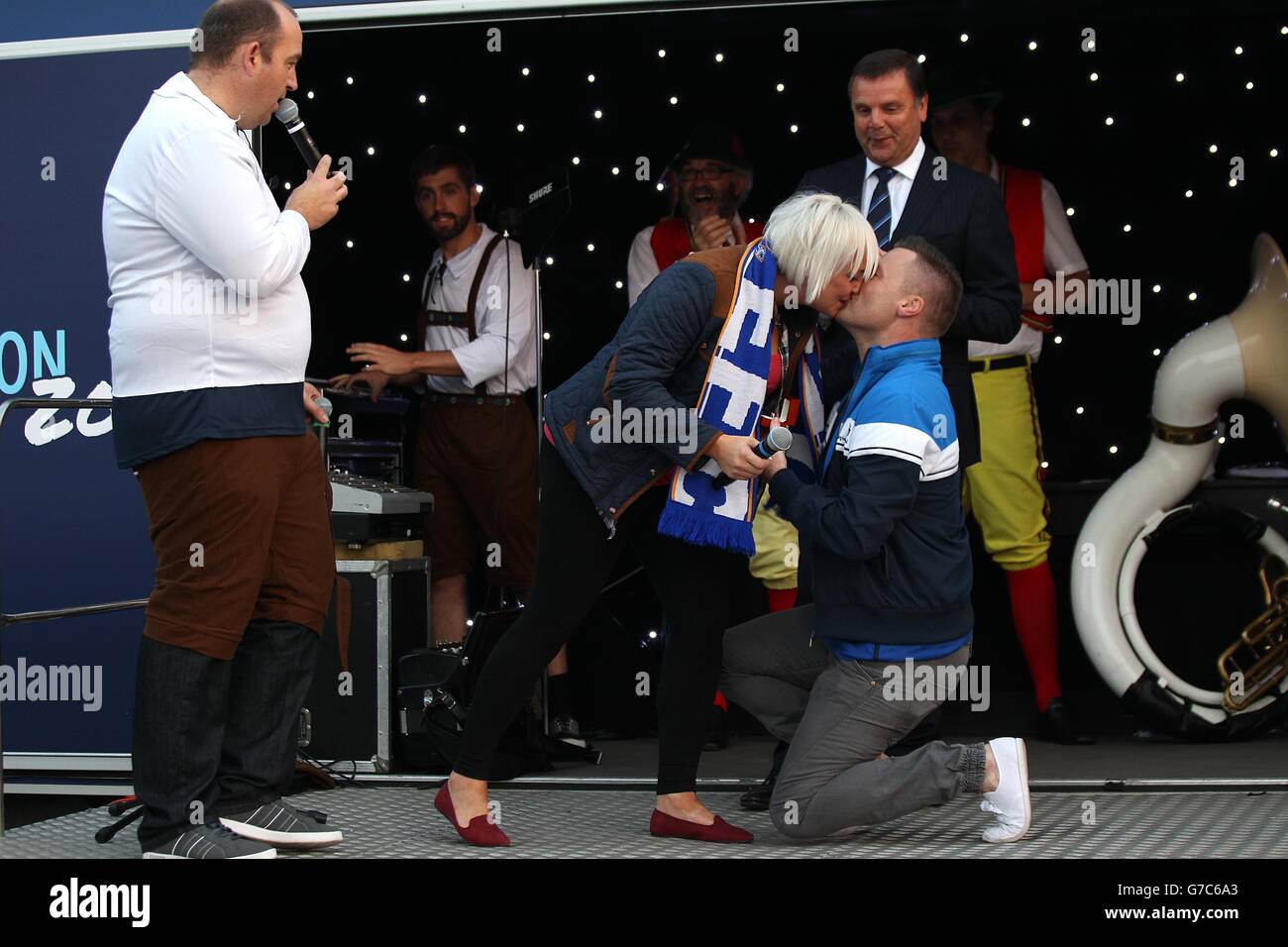 A wedding proposal on stage in the fan zone hires stock photography