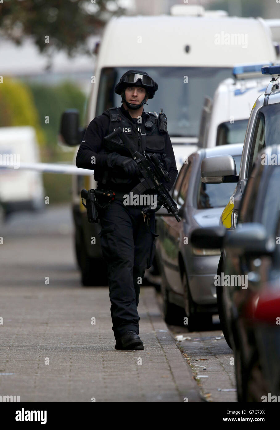 An armed police officer near to the scene in Boyd Street in the Crosshill area of Glasgow, after police were called to an incident. Stock Photo