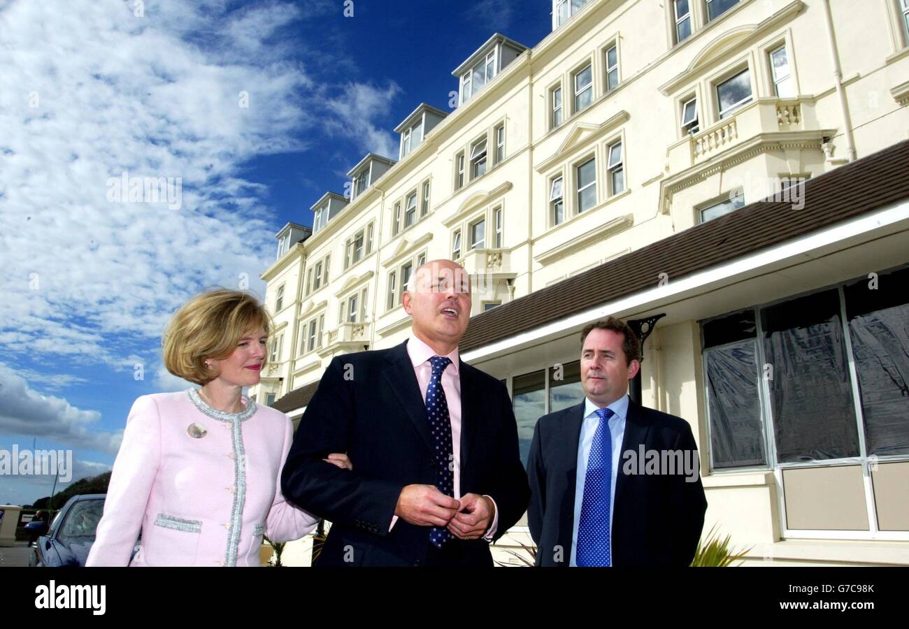 Former Leader of the Conservative Party Iain Duncan Smith arrives with his wife Betsy and is greeted by the Chairman of the Conservative Party Liam Fox at the Conservative Party Conference. Stock Photo