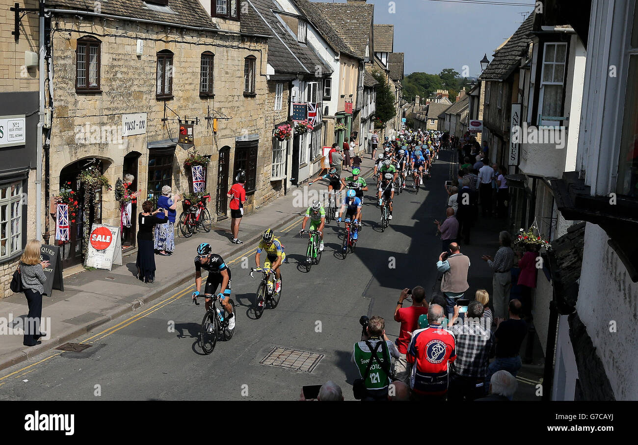 The Peleton passes through the town of Winchcombe in Gloucestershire during the stage four of the 2014 Tour of Britain. Stock Photo