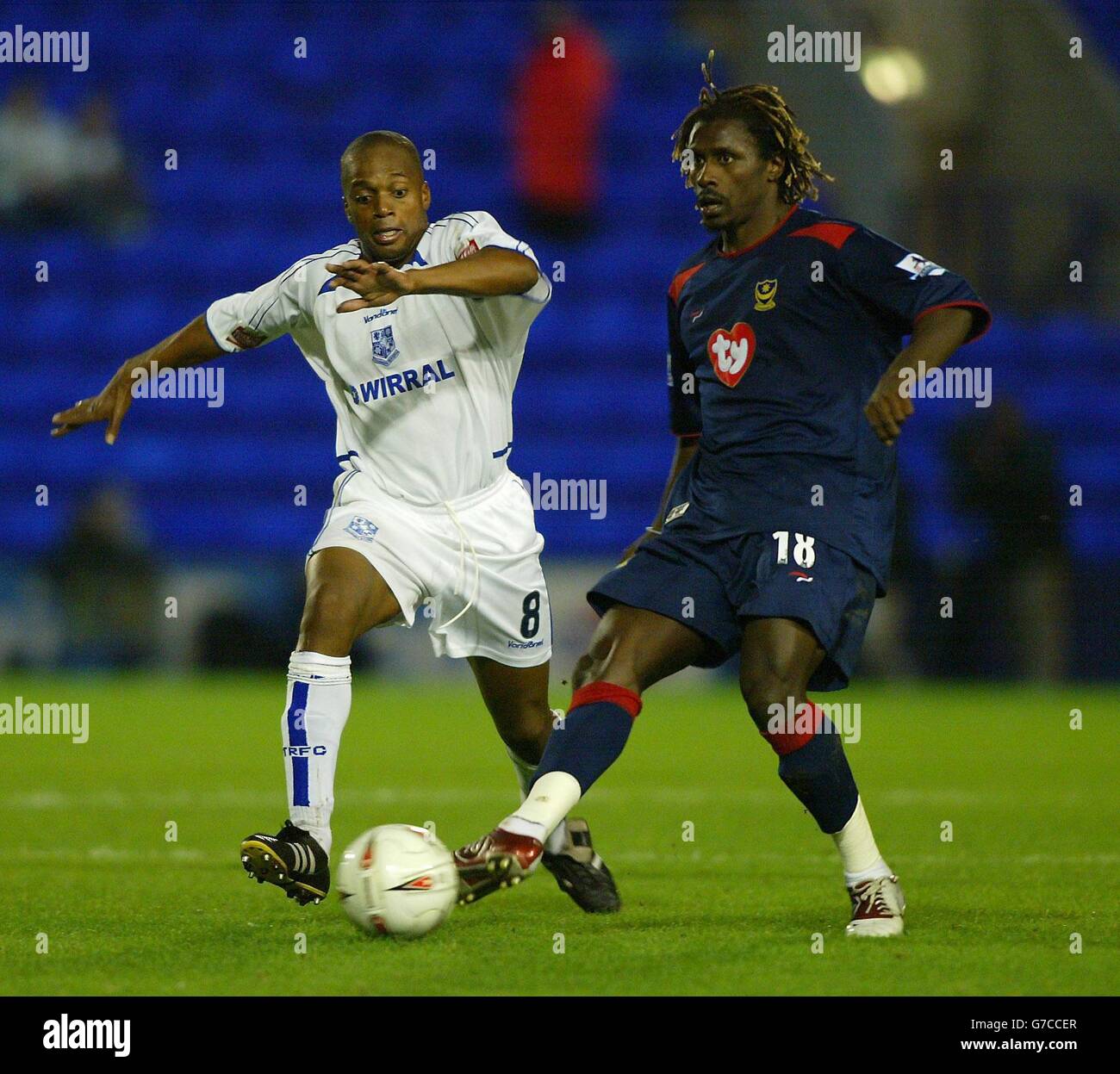 Portsmouth's Aliou Cisse (right) battles with Tranmere Rovers' Mark Rankineduring their Carling Cup second round match at Prenton Park, Birkenhead. Stock Photo