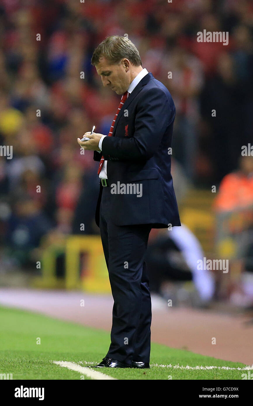 Liverpool manager Brendan Rodgers making notes on the touchline during the UEFA Champions League, Group B match at Anfield, Liverpool. Stock Photo