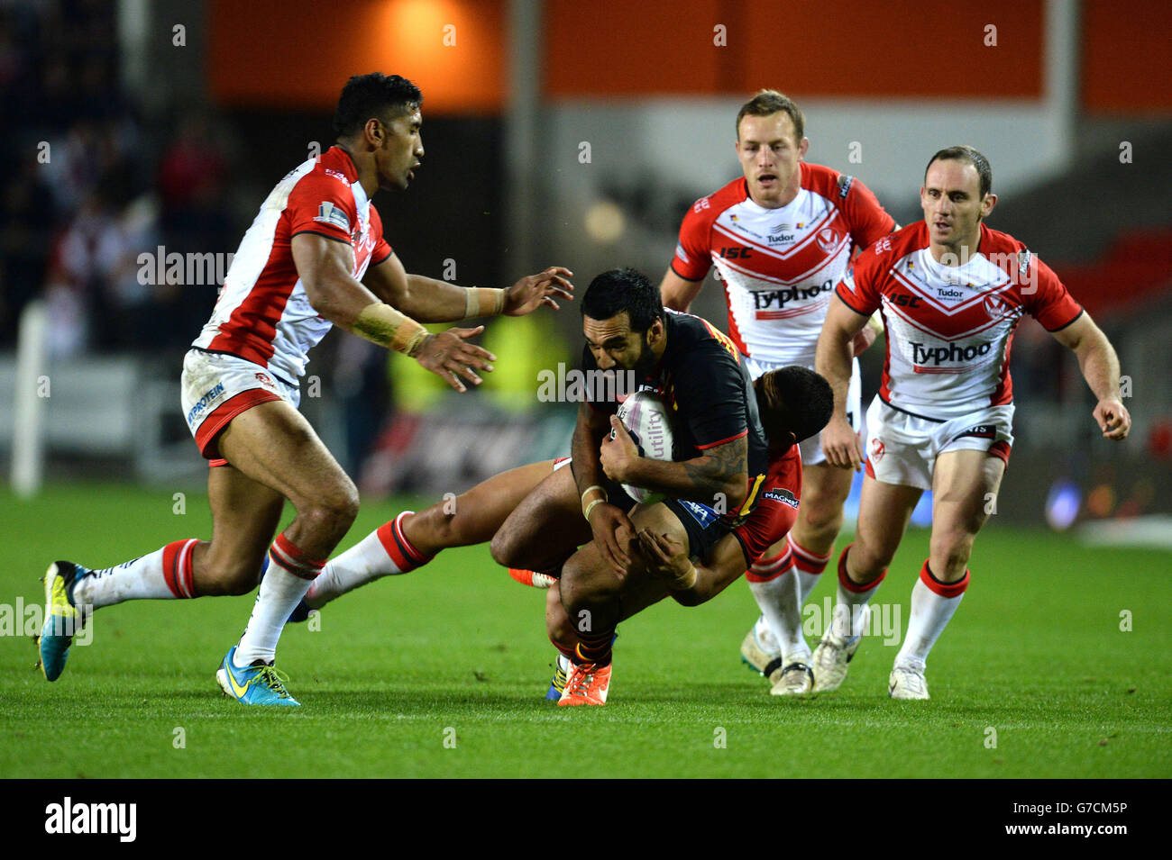 Catalan Dragons' Zeb Taia is tackled by St Helens' Sia Soliola (left) and Willie Manu during the First Utility super League Play Off match at Langtree Park, St Helens. Stock Photo