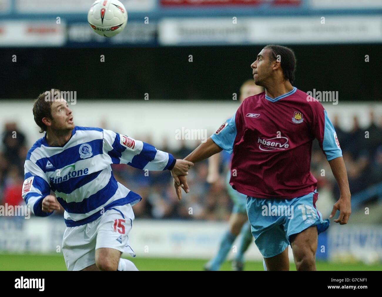 Queen's Park Rangers Jamie Cureton, left, holds off West Ham's Anton Ferdinand as they battle for the ball during their Coca-Cola Championship match at Loftus Road, west London, Saturday October 16, 2004. NO UNOFFICIAL CLUB WEBSITE USE. Stock Photo