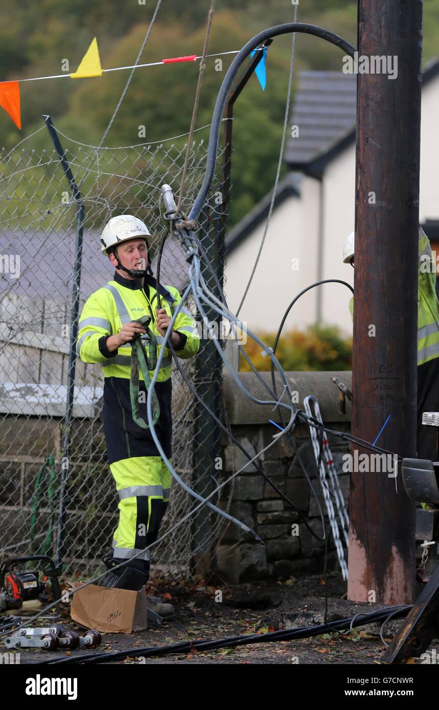 A repair worker from Northern Ireland Electricity works to restore