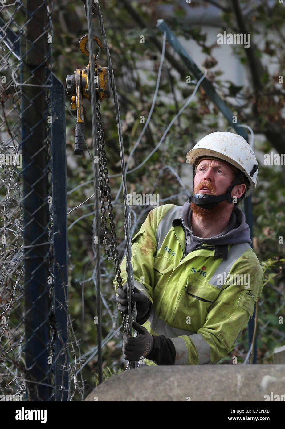 A repair worker from Northern Ireland Electricity works to restore